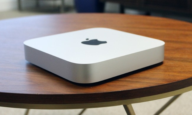 The Mac mini on a wooden desk.